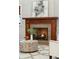 Close-up of a fireplace featuring a wooden mantle and stone surround, with a cozy coffee table and decor at 1056 Wharf Indigo Pl, Mount Pleasant, SC 29464