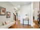Inviting foyer with hardwood floors, a cozy white settee, and classic decor at 1056 Wharf Indigo Pl, Mount Pleasant, SC 29464