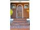 Inviting front door with beautiful wood detailing, framed by classic lantern lights and small windows at 1056 Wharf Indigo Pl, Mount Pleasant, SC 29464