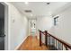 Bright hallway with hardwood floors and white trim showcasing the home's design and flow at 1056 Wharf Indigo Pl, Mount Pleasant, SC 29464