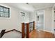 Upstairs hallway with hardwood flooring and natural light from a window at 1056 Wharf Indigo Pl, Mount Pleasant, SC 29464