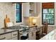 Bright kitchen featuring stone backsplash, modern appliances and hardwood floors at 1056 Wharf Indigo Pl, Mount Pleasant, SC 29464