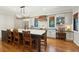Well-lit kitchen with white cabinets, chevron backsplash, and a dark island with bar seating at 1056 Wharf Indigo Pl, Mount Pleasant, SC 29464