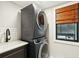 A laundry room has a new washer and dryer and window with blind at 1056 Wharf Indigo Pl, Mount Pleasant, SC 29464