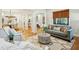 Open-concept living space with hardwood floors, stylish decor, and ample natural light at 1056 Wharf Indigo Pl, Mount Pleasant, SC 29464