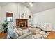 Bright living room features a stone fireplace, hardwood floors, and elegant furnishings at 1056 Wharf Indigo Pl, Mount Pleasant, SC 29464