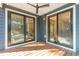 Covered porch with a ceiling fan, outdoor lighting, and sliding doors leading to the home's interior at 1056 Wharf Indigo Pl, Mount Pleasant, SC 29464