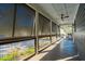 Enclosed porch offering views through screened openings, complemented by a ceiling fan and outdoor seating at 1056 Wharf Indigo Pl, Mount Pleasant, SC 29464