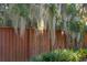 Wood privacy fence covered with Spanish moss in backyard with lush greenery at 1056 Wharf Indigo Pl, Mount Pleasant, SC 29464