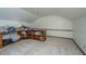 Unfinished attic with carpet flooring and wooden shelves, offering ample storage space at 106 Dunmow Dr, Summerville, SC 29485