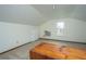 Finished attic with carpet, window, and white walls is a great space at 106 Dunmow Dr, Summerville, SC 29485