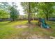 Backyard area with playground and a fence, with trees providing ample shade at 106 Dunmow Dr, Summerville, SC 29485