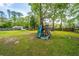 Spacious backyard featuring mature trees, a play structure, and a storage shed at 106 Dunmow Dr, Summerville, SC 29485