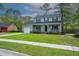 Charming two-story home featuring a covered porch, attached garage, and a well-manicured lawn at 106 Dunmow Dr, Summerville, SC 29485