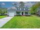 Two-story home with a covered front porch, attached garage, and a well-maintained lawn at 106 Dunmow Dr, Summerville, SC 29485