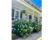 Inviting covered porch with white railings and vibrant hydrangea bushes, offering a relaxing outdoor space at 106 Dunmow Dr, Summerville, SC 29485