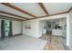 Bright living room featuring wood beams and a view into the kitchen at 106 Dunmow Dr, Summerville, SC 29485