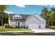 Charming single-story home with light blue siding, stone accents, and a three-car garage at 1126 Darling St, Summerville, SC 29485
