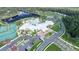 Gorgeous aerial view showcasing community amenities, including a pool, clubhouse, tennis courts, and lake at 1128 Darling St, Summerville, SC 29485