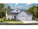 Charming one-story home featuring a two-car garage, covered porch, and manicured lawn at 1128 Darling St, Summerville, SC 29485
