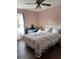 Charming bedroom featuring a decorative quilt, light pink walls, and a built-in vanity desk near the window at 129 Bramwell Dr, Summerville, SC 29485