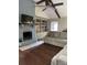 Comfortable living room with painted brick fireplace, built-in shelving, ceiling fan, and nice flooring at 129 Bramwell Dr, Summerville, SC 29485