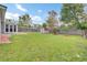 Expansive backyard featuring lush green grass, mature trees, shed, and a wooden privacy fence at 1302 Camden Xing, Hanahan, SC 29410