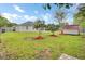Well-maintained backyard with green lawn, small shed, mulched trees, and a partial view of the home's exterior at 1302 Camden Xing, Hanahan, SC 29410