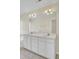Bathroom featuring a double vanity with large mirror, bathtub, ceramic tile flooring, and sconce lighting at 1302 Camden Xing, Hanahan, SC 29410