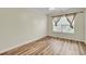 Inviting bedroom features wood-look flooring and a window with decorative curtains at 1302 Camden Xing, Hanahan, SC 29410