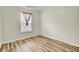 Bright bedroom with wood-look flooring and a window featuring decorative curtains at 1302 Camden Xing, Hanahan, SC 29410