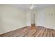 Cozy bedroom with wood-look flooring, a ceiling fan, and an open doorway at 1302 Camden Xing, Hanahan, SC 29410