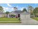 Charming single-story home featuring a well-manicured lawn, flower beds, and a two-car garage at 1302 Camden Xing, Hanahan, SC 29410