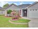Close-up of a home's landscaped yard with vibrant azalea bushes and red mulch at 1302 Camden Xing, Hanahan, SC 29410
