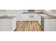 Clean white kitchen cabinets, stove, and stainless steel appliances in an open floorplan at 1302 Camden Xing, Hanahan, SC 29410