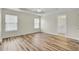 Spacious main bedroom with tray ceiling, wood-look flooring, and an ensuite bathroom at 1302 Camden Xing, Hanahan, SC 29410