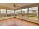Bright sunroom with wood flooring, large windows, and ceiling fan, perfect for enjoying natural light at 1302 Camden Xing, Hanahan, SC 29410