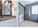 A well-lit bathroom with a single sink vanity, a granite countertop, and tile flooring at 1342 Dennis Blvd, Moncks Corner, SC 29461
