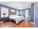 A cozy bedroom with hardwood floors, white walls, and natural light from many windows at 1342 Dennis Blvd, Moncks Corner, SC 29461
