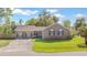 Charming brick home with manicured lawn, mature trees, and a welcoming driveway on a sunny day at 1342 Dennis Blvd, Moncks Corner, SC 29461