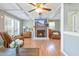 Inviting living room featuring a cozy fireplace, coffered ceilings, hardwood floors and natural light from many windows at 1342 Dennis Blvd, Moncks Corner, SC 29461