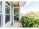 Private outdoor balcony with fern planters, a view of the trees and a peak into the living room at 135 Pier View # 305, Charleston, SC 29492