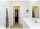 Bathroom featuring double vanity, white cabinets, and an open closet at 135 Pier View # 305, Charleston, SC 29492