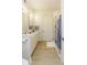 Bright bathroom featuring double sinks, white cabinets, and a glass shower at 135 Pier View # 305, Charleston, SC 29492
