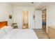 Bright bedroom featuring light hardwood floors, white walls, and an ensuite bathroom at 135 Pier View # 305, Charleston, SC 29492