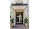 Welcoming building entrance framed by potted plants at 135 Pier View # 305, Charleston, SC 29492