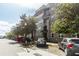 Modern apartment building exterior with balconies, street parking, and mature trees at 135 Pier View # 305, Charleston, SC 29492
