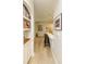 Hallway leading to kitchen with counter seating and custom shelving at 135 Pier View # 305, Charleston, SC 29492