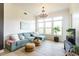 Living room with many windows offering plenty of sunlight, hardwood floors, and modern furniture at 135 Pier View # 305, Charleston, SC 29492