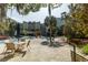 Community pool area with palm trees, lounge chairs, tables, and lush landscaping at 135 Pier View # 305, Charleston, SC 29492